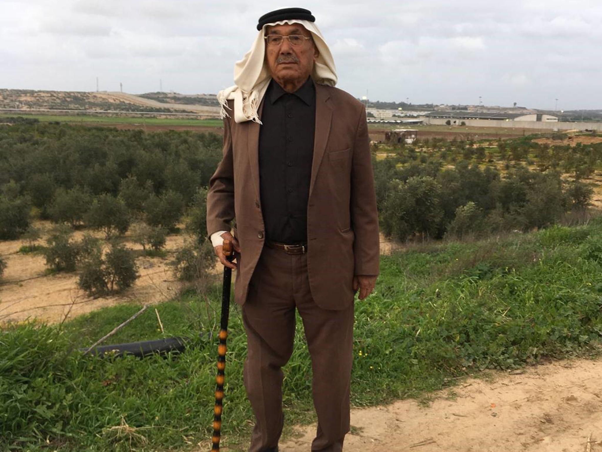 Abu Othman, mukhtar of Beyt Hanoun, saw the 1948 refugees arrive in Gaza. Behind him is the Erez checkpoint and Israel’s barrier wall