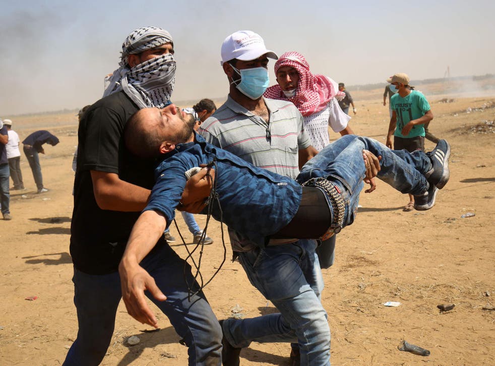 A wounded Palestinian is evacuated during clashes with Israeli forces along the border with the Gaza strip