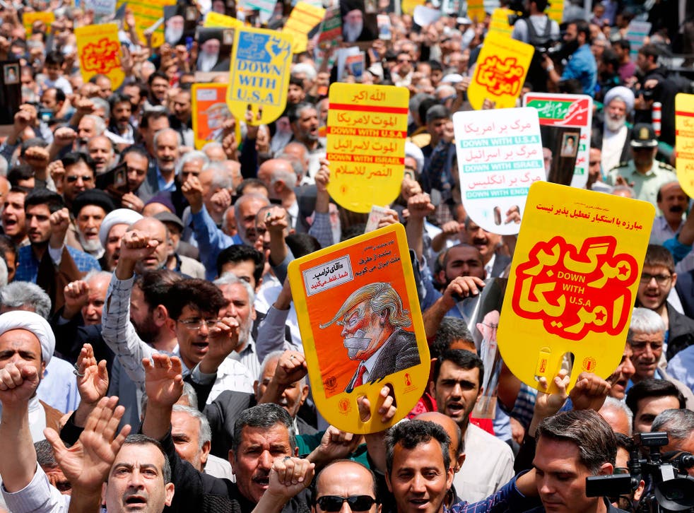 Iranians hold anti-US placards and shout slogans during a demonstration after Friday prayers in the capital Tehran on 11 May