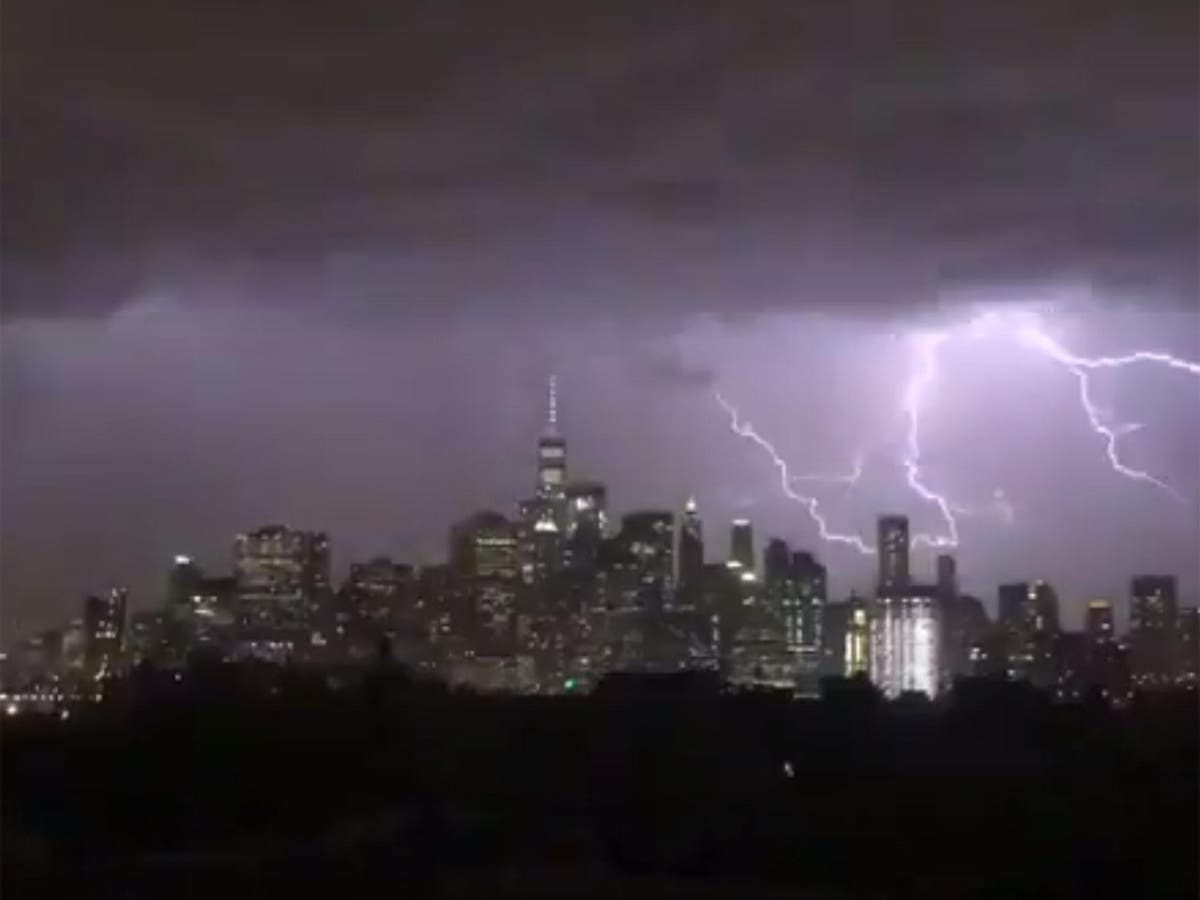 US weather latest New York skyline lit up by forked lightning The