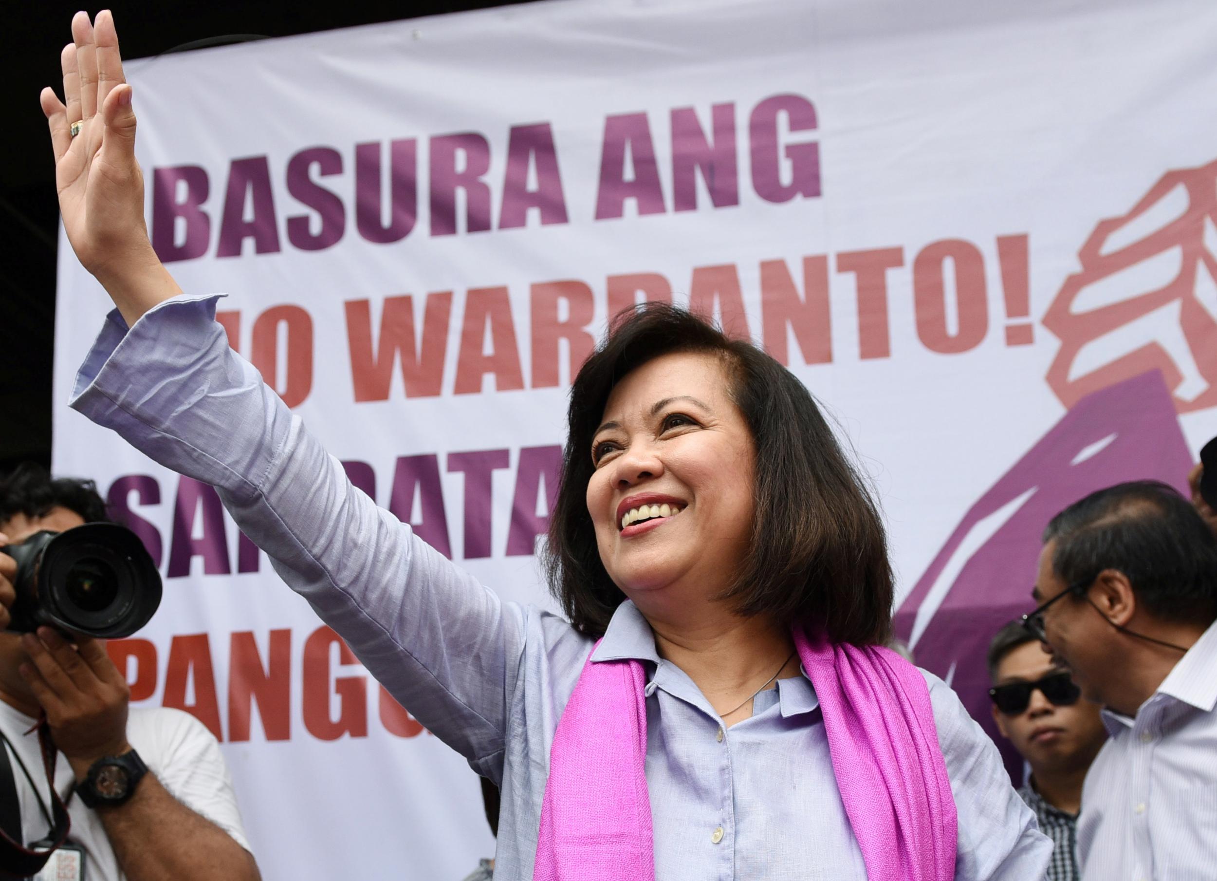 Maria Lourdes Sereno waves to supporters at a rally outside the supreme court in Manila