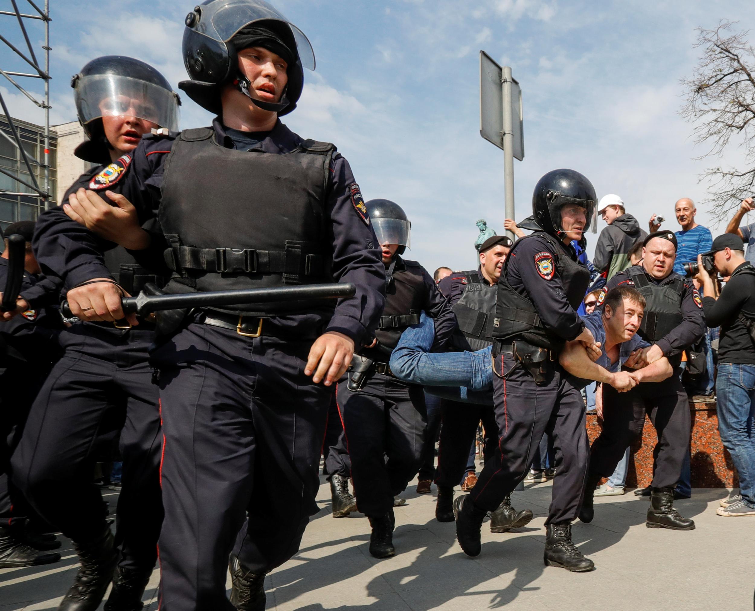 Policemen detain a protester ahead of President Vladimir Putin's inauguration ceremony, in May (Reuters)