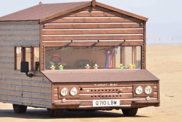 A motorised shed has broken a land speed record after its owner hit 100mph driving along a Welsh beach