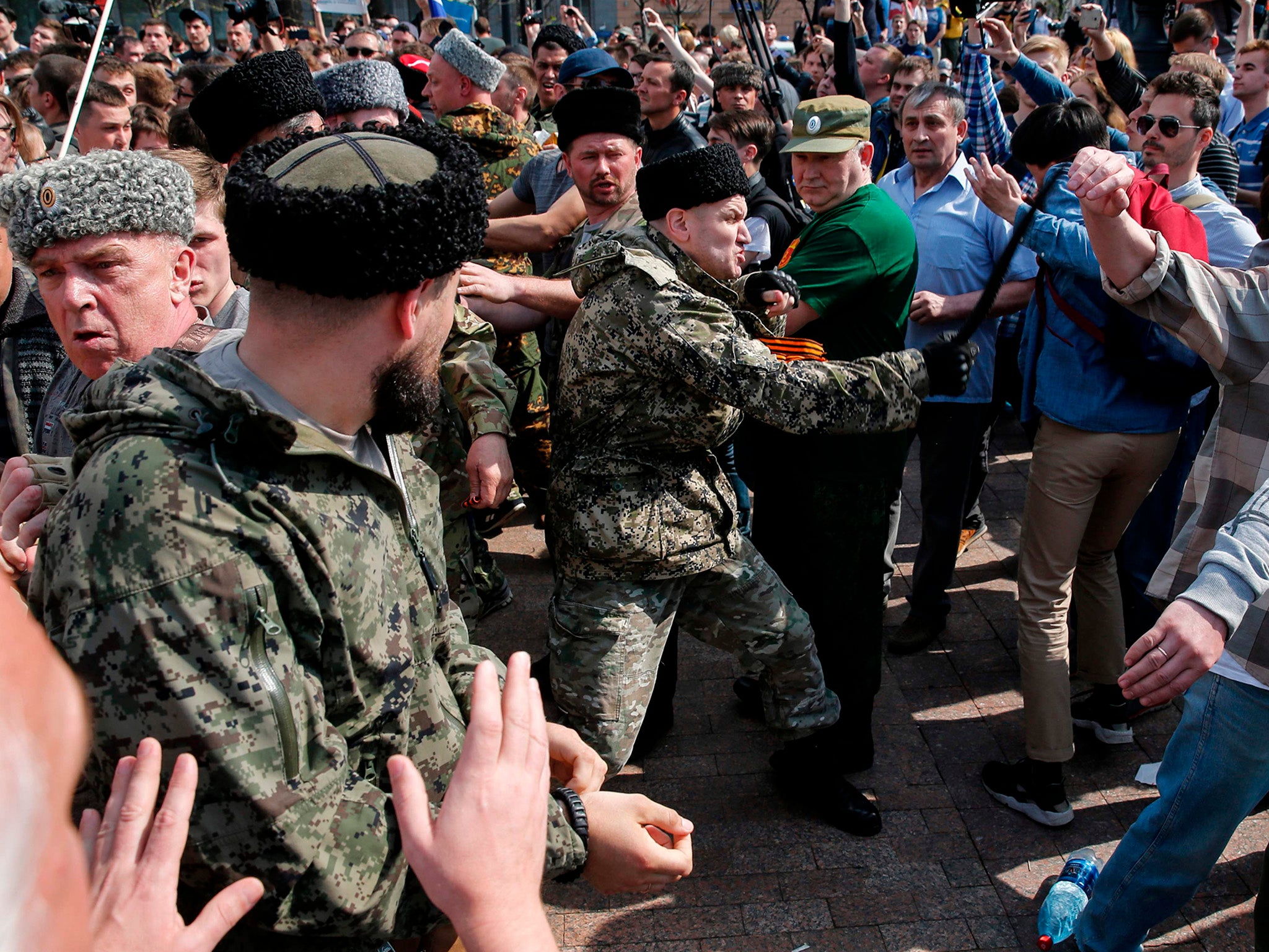 Cossacks scuffle with opposition supporters in Moscow during an unauthorised anti-Putin rally called by opposition leader Alexei Navalny earlier this month