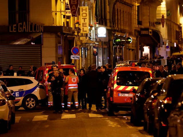 Paris’ mayor Anne Hidalgo stands amongst emergency service members, firefighters and policemen in a street in Paris centre after one person was killed and several injured by a man armed with a knife, who was shot dead by police