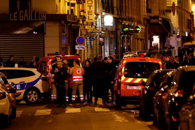 Paris’ mayor Anne Hidalgo stands amongst emergency service members, firefighters and policemen in a street in Paris centre after one person was killed and several injured by a man armed with a knife, who was shot dead by police
