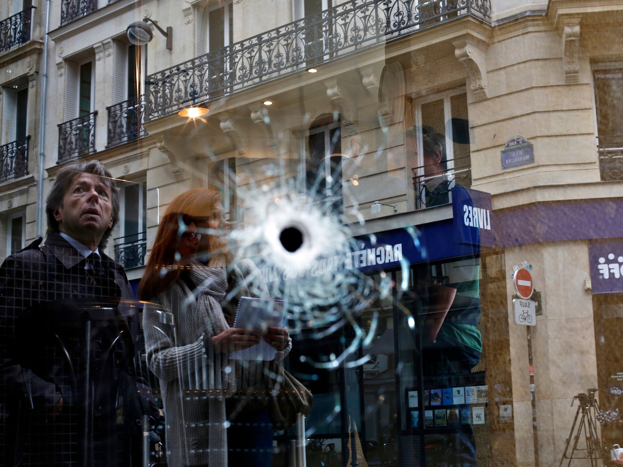 A bullet hole seen on the window of a cafe located near the area where the assailant of a knife attack was shot dead by police officers, in central Paris