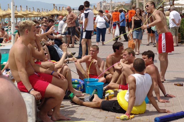 Young men drinking alcohol from buckets in Mallorca