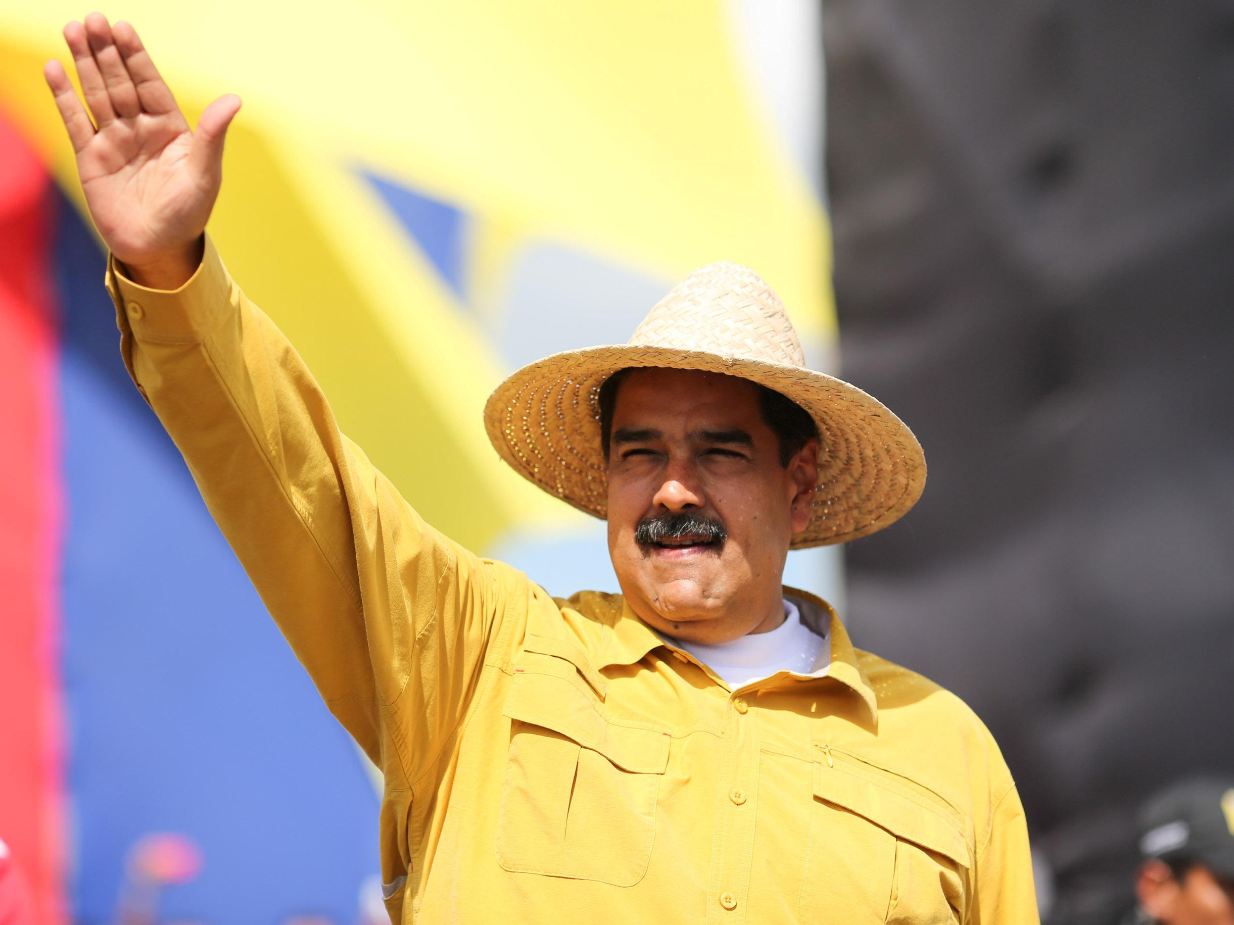 Venezuela's President Nicolas Maduro waves during a campaign rally in San Fernando