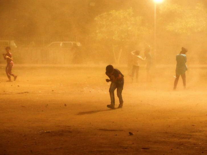 People trying to shelter from a dust storm in New Delhi over the weekend