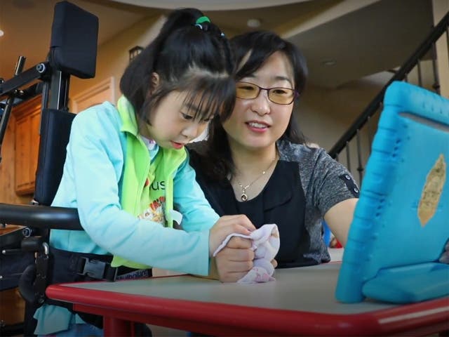 Soo-Kyung Lee and Yuna at home. Yuna, now aged 8, suffers from a brain disorder related to the FOXG1 gene