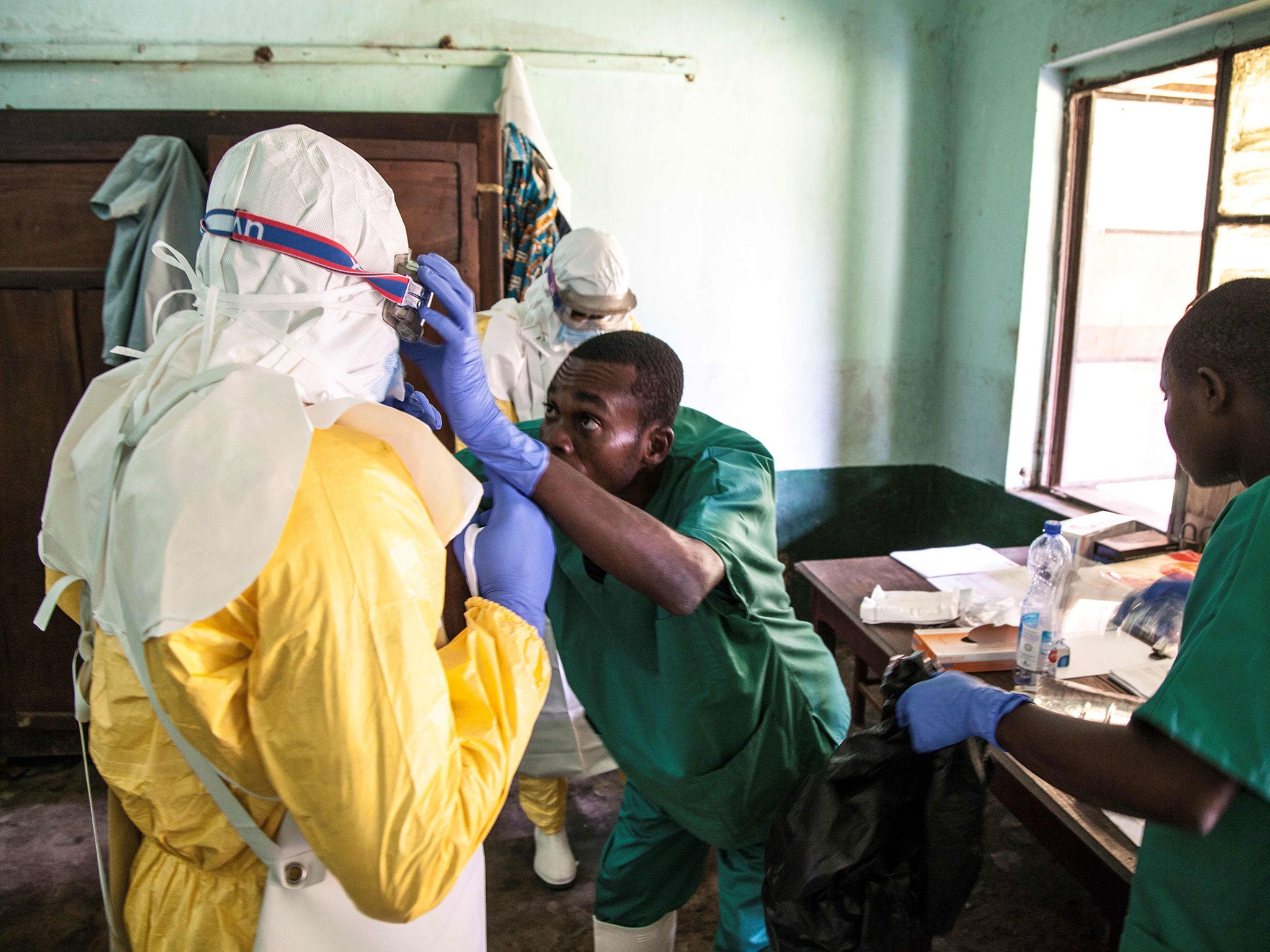 Health workers wear protective equipment as they prepare see suspected Ebola patients at Bikoro Hospital