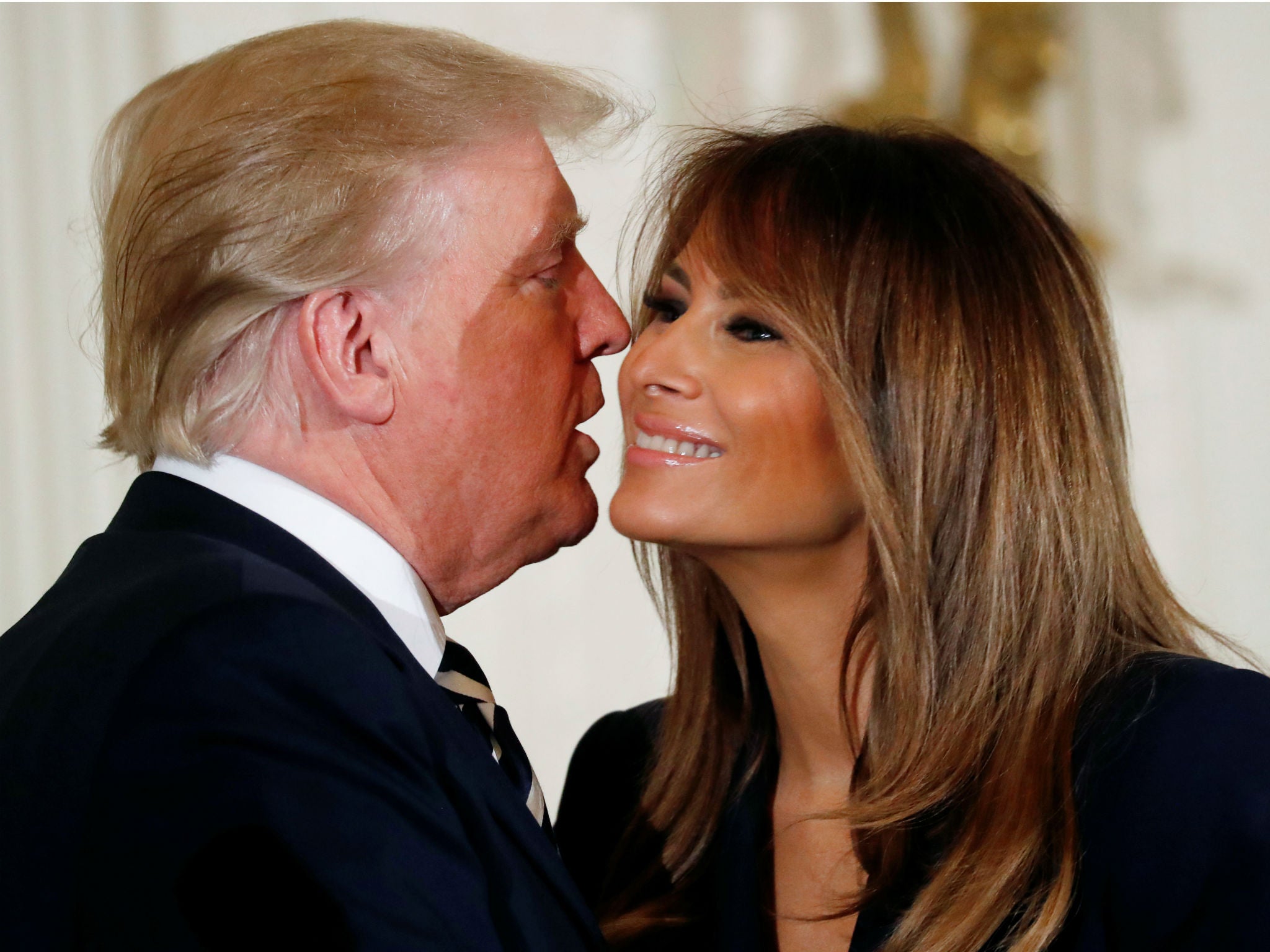 Donald Trump kisses his wife first lady Melania Trump