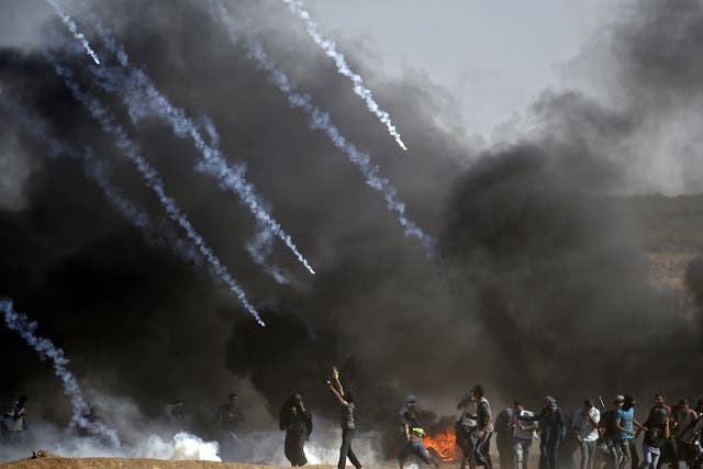 Tear gas is fired at Palestinian protesters by Israeli forces near the border between the Gaza strip and Israel