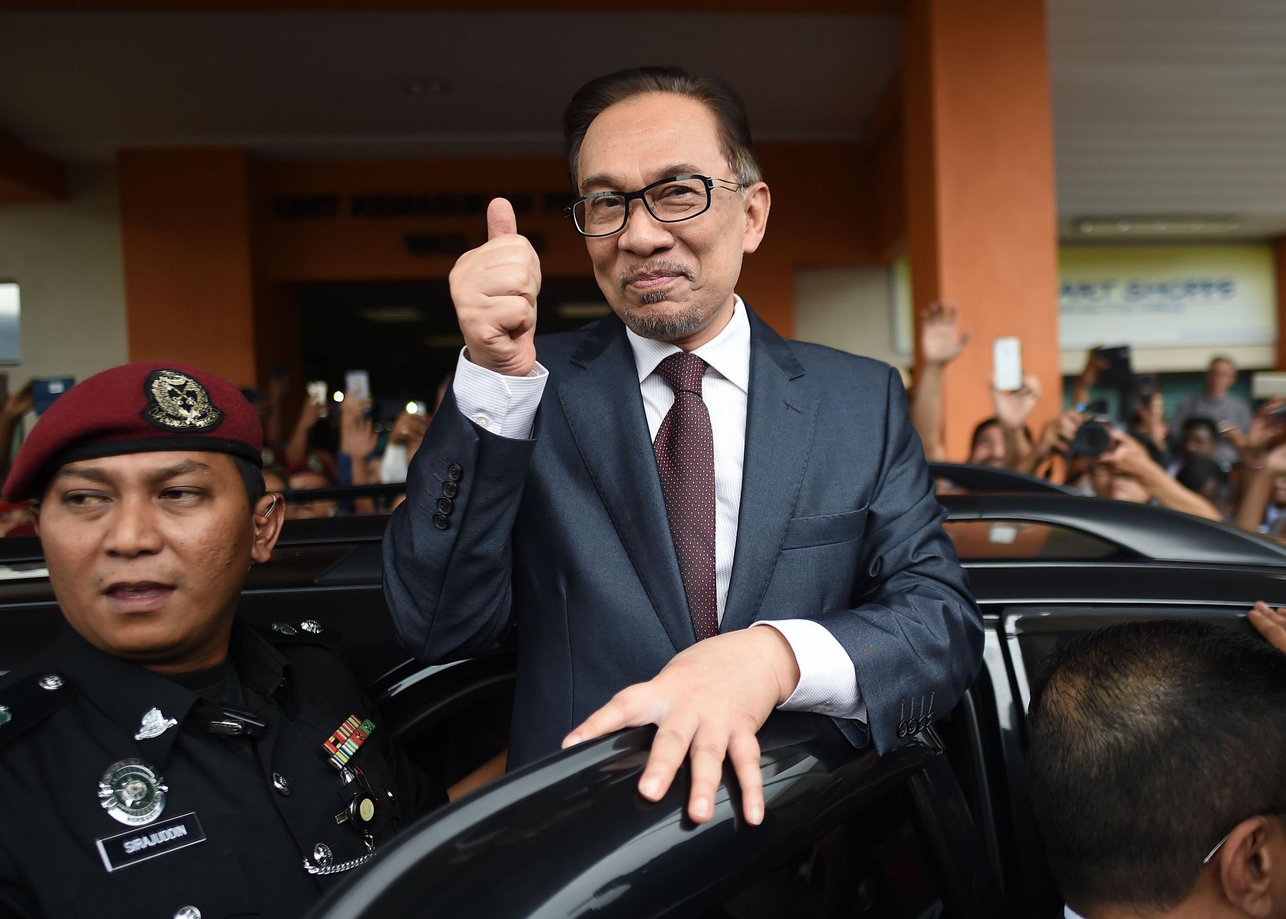 Anwar Ibrahim greets supporters after his release from detention in hospital in Kuala Lumpur on Wednesday