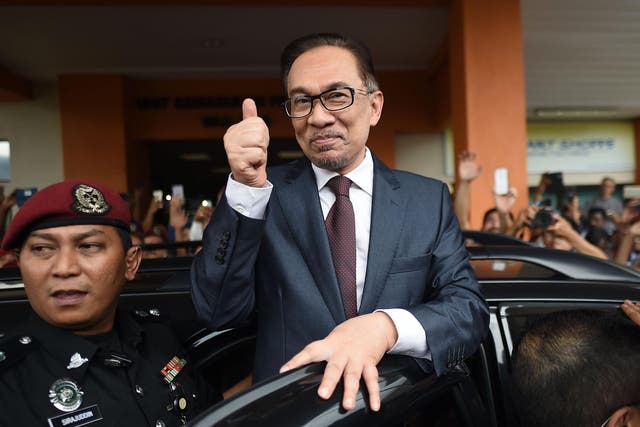 Anwar Ibrahim greets supporters after his release from detention in hospital in Kuala Lumpur on Wednesday