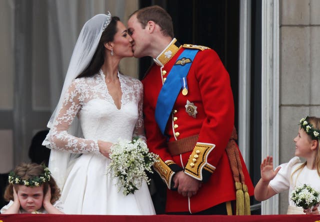 Grace van Cutsem covers her ears as the Duke and Duchess of Cambridge kiss on the balcony at Buckingham Palace on the day of their wedding in 2011.