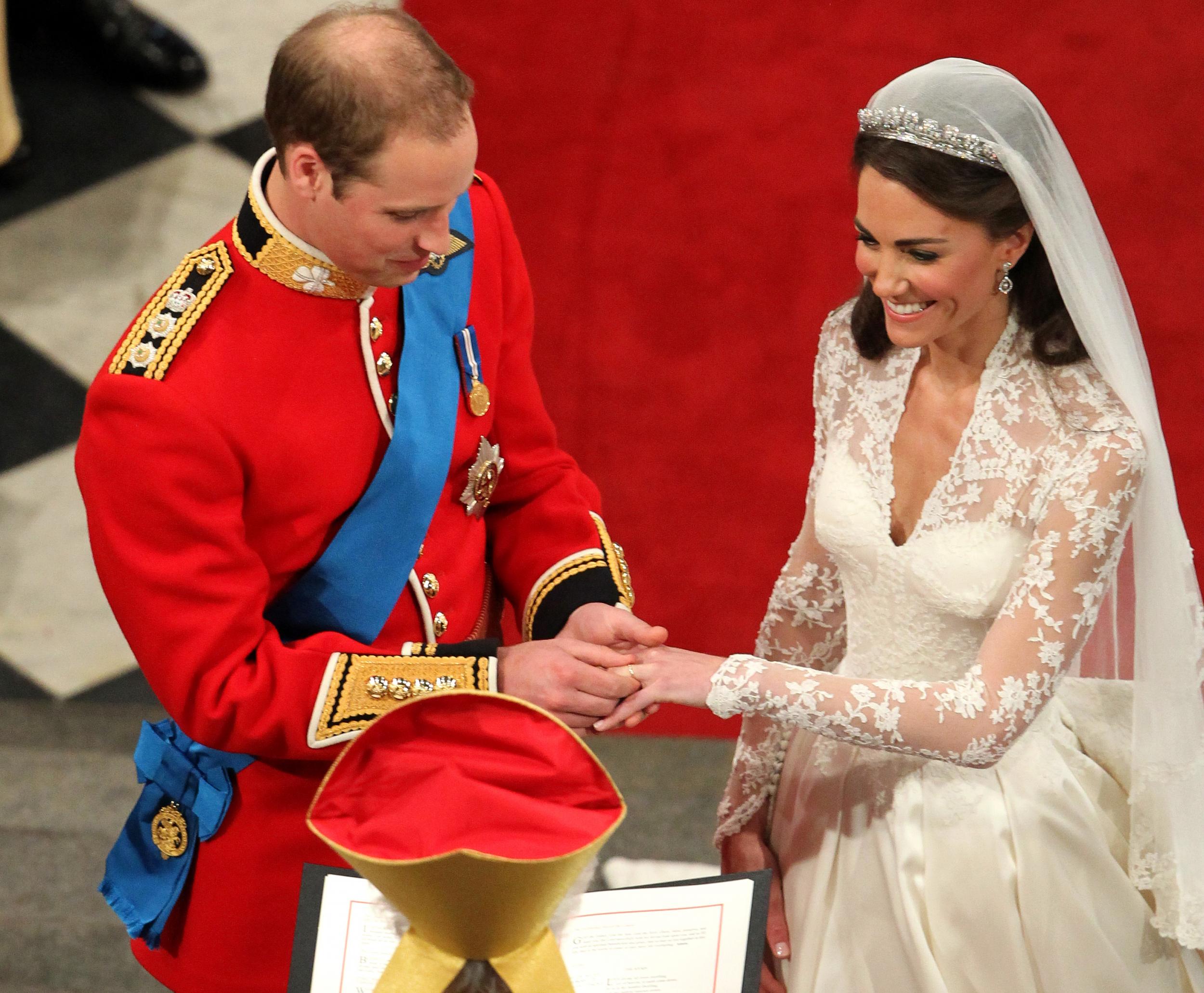 The Duchess of Cambridge smiled as the Duke of Cambridge placed the wedding ring on her finger during their wedding ceremony