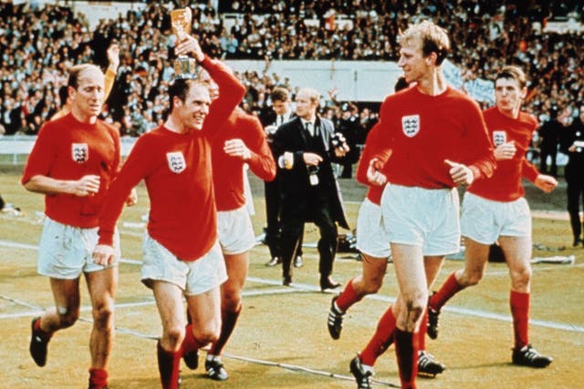 The Three Lions star (pictured holding trophy) celebrates with his teammates