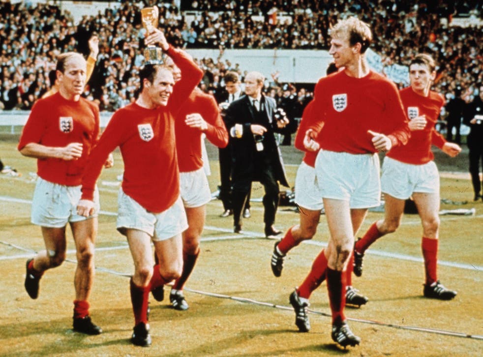 The Three Lions star (pictured holding trophy) celebrates with his teammates