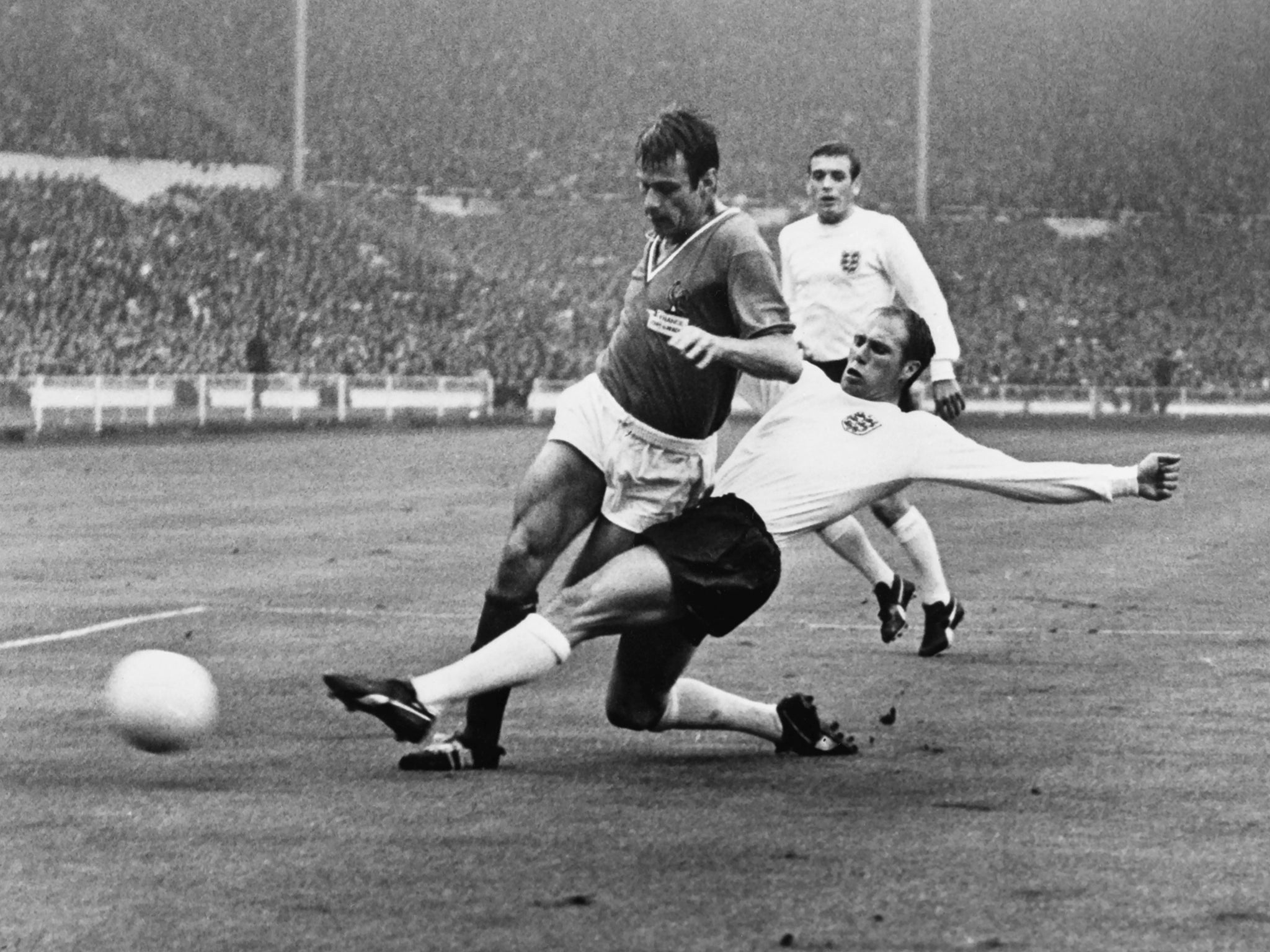 Wilson tackles French footballer Philippe Goudet at the 1966 World Cup