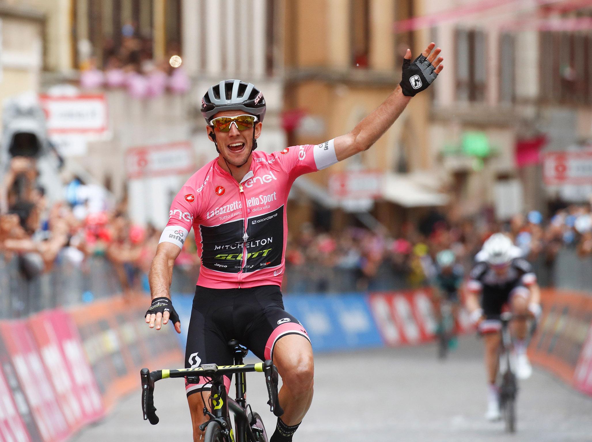 Simon Yates celebrates crossing the line in Osimo