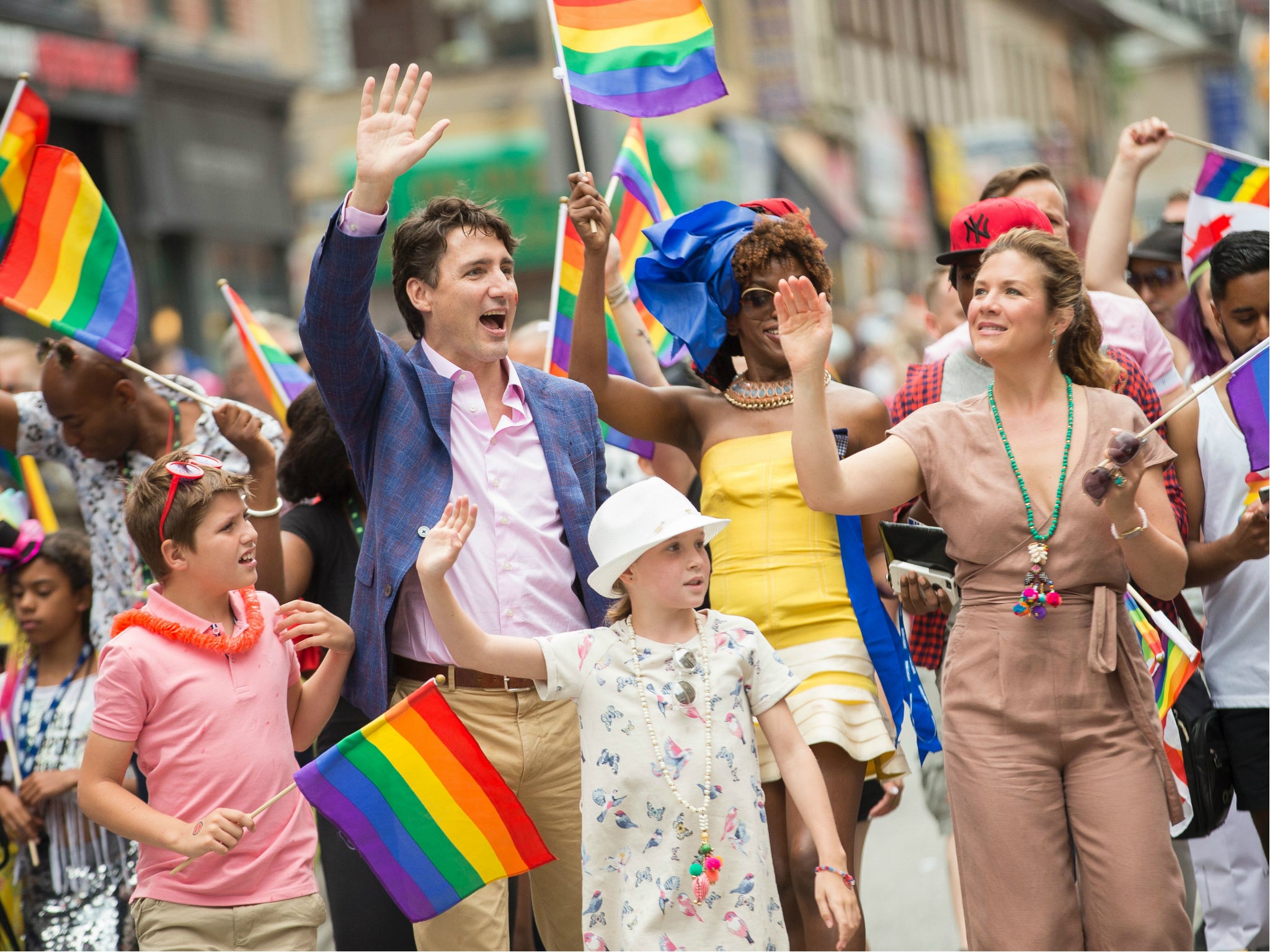 Canadian Prime Minister Justin Trudeau waves to the crowd as he, his wife Sophie Gregoire Trudeau and their children march in the Pride Parade in Toronto, 25 June 2017