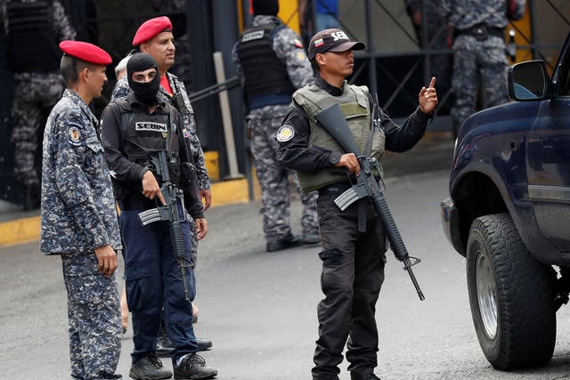 Members of the Bolivarian National Intelligence Service (SEBIN) stand guard outside the El Helicoide detention center, in Caracas, Venezuela, where a riot erupted