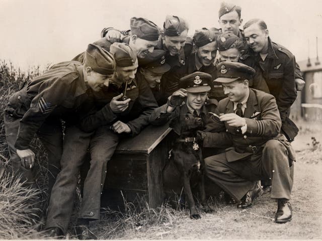 Wing commander Guy Gibson and the RAF 617 Squadron crew with his dog, N****r
