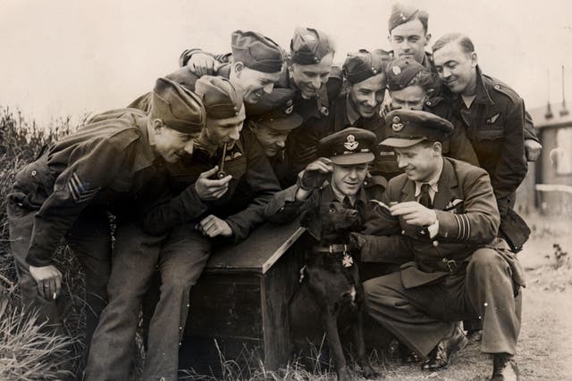 Wing commander Guy Gibson and the RAF 617 Squadron crew with his dog, N****r