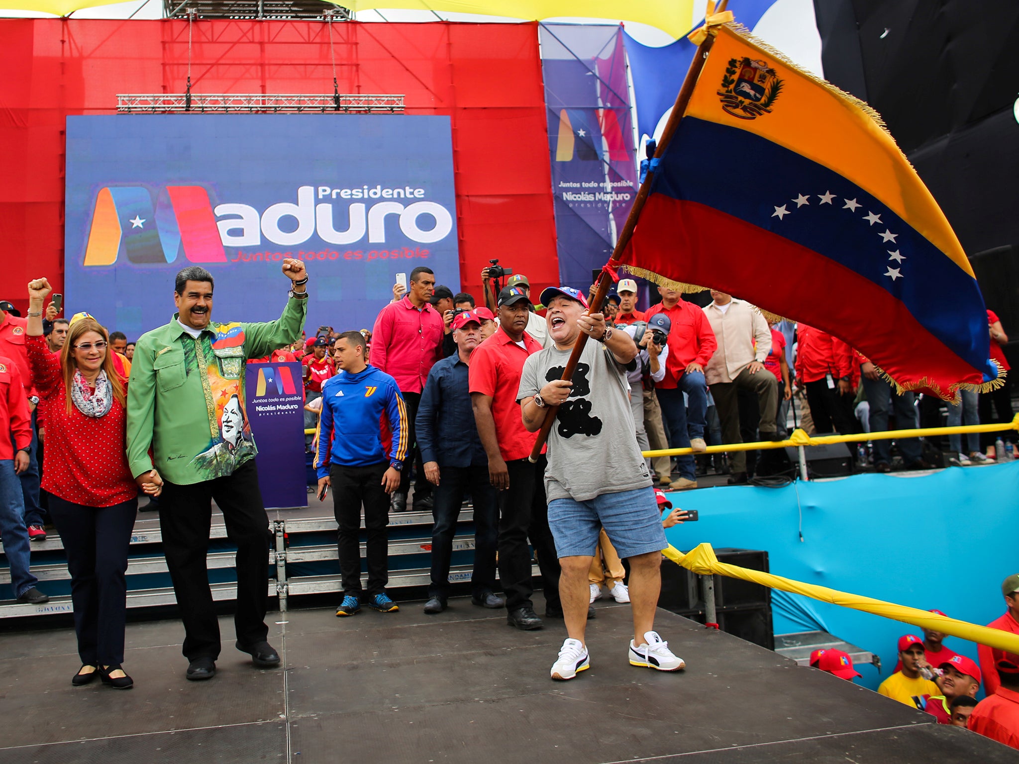 Venezuela's President Nicolas Maduro, his wife Cilia Flores and former Argentinian soccer player Diego Maradona greet supporters during a campaign rally in Caracas