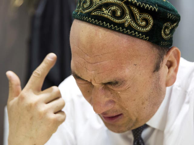 Omir Bekali, 42, cries as he recalls the details of his internment in China's Xinjiang province