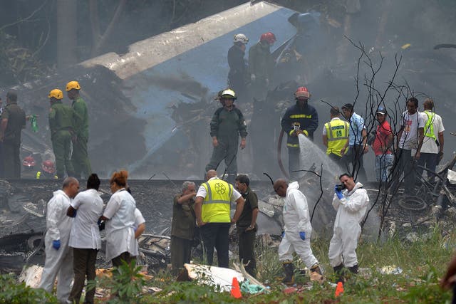Emergency personnel at the site of an aircraft crash site near Havana’s Jose Marti airport