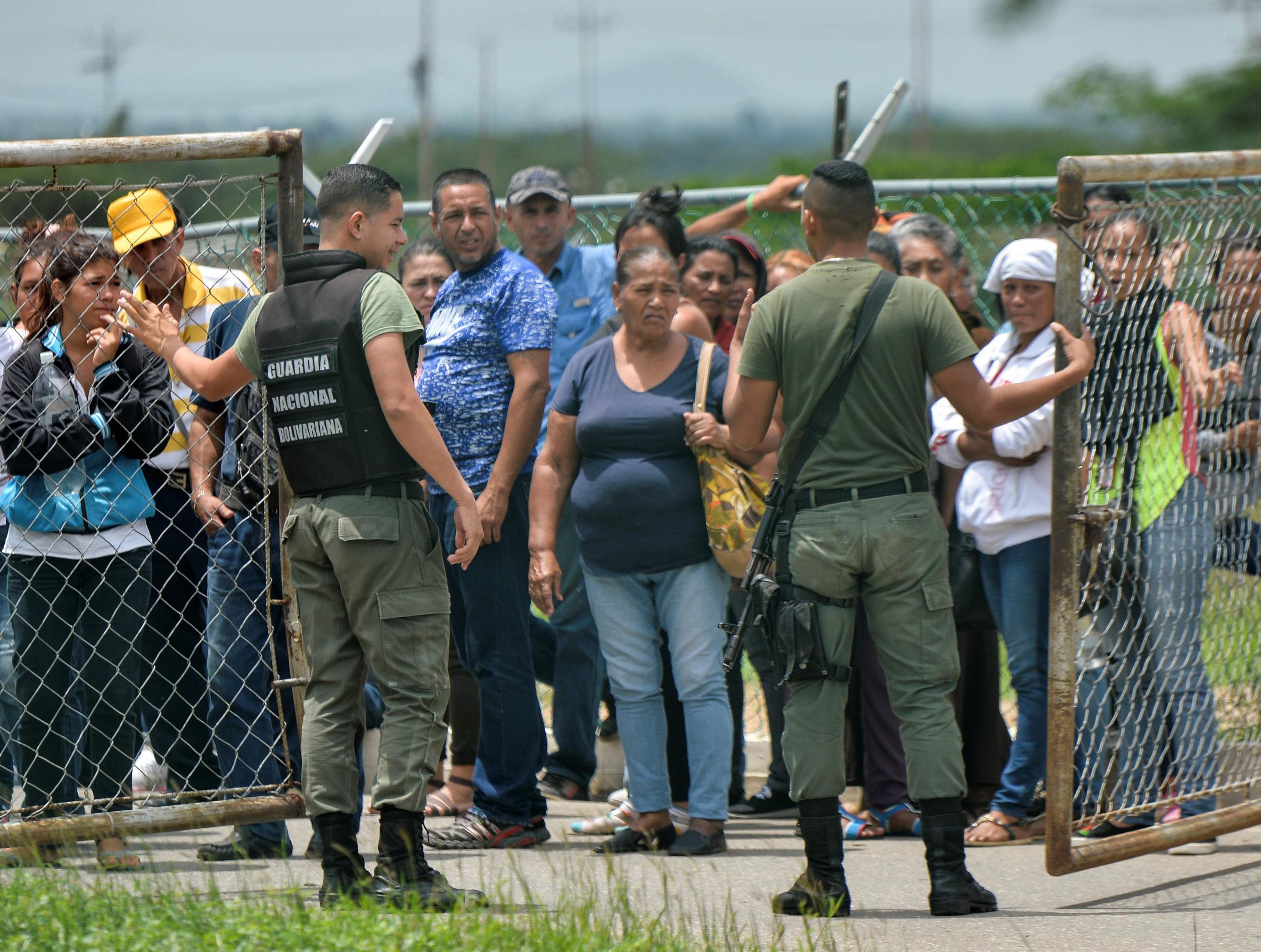 Relatives of inmates gather outside the Fenix Penitentiary following a riot