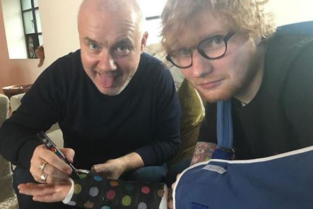Ed Sheeran poses with artist Damien Hirst after fracturing his wrist
