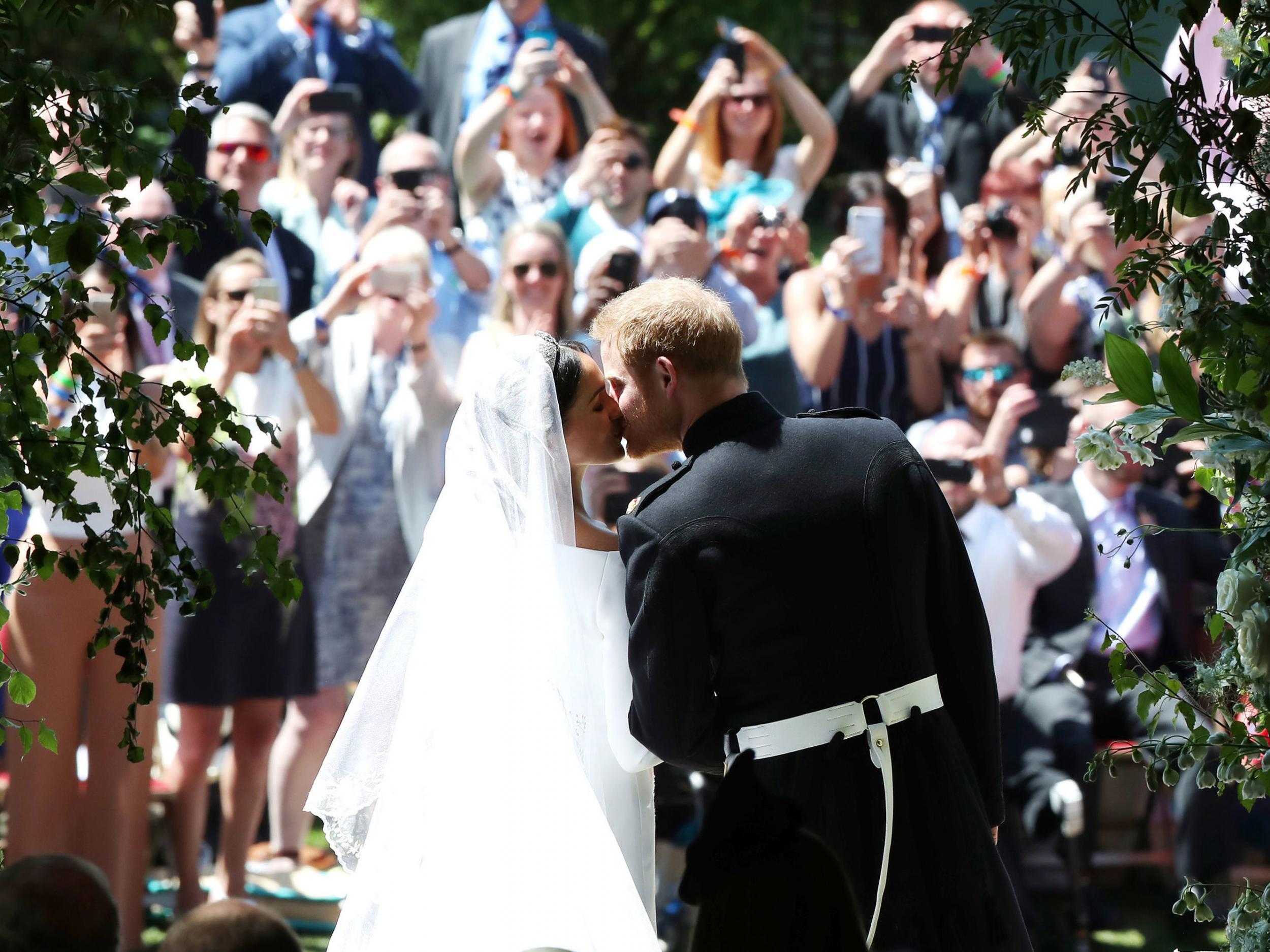 Prince Harry and Meghan Markle kiss on the steps of St George’s Chapel in Windsor Castle after their wedding