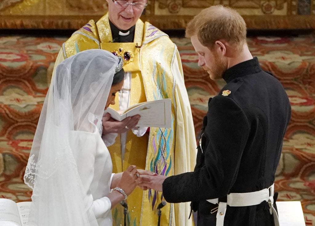 The Duchess of Sussex places a ring on her new husband's finger