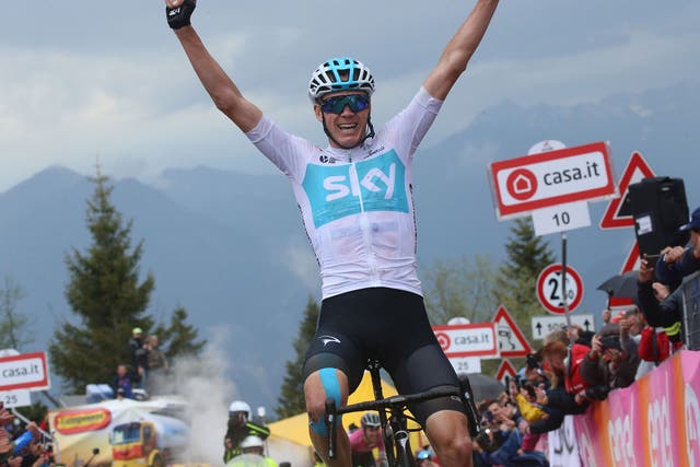 Chris Froome celebrates as he crosses the line in first place