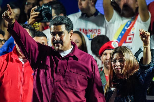 Venezuelan President Nicolas Maduro (L) celebrates with his wife Cilia Flores after the results are declared late on Sunday