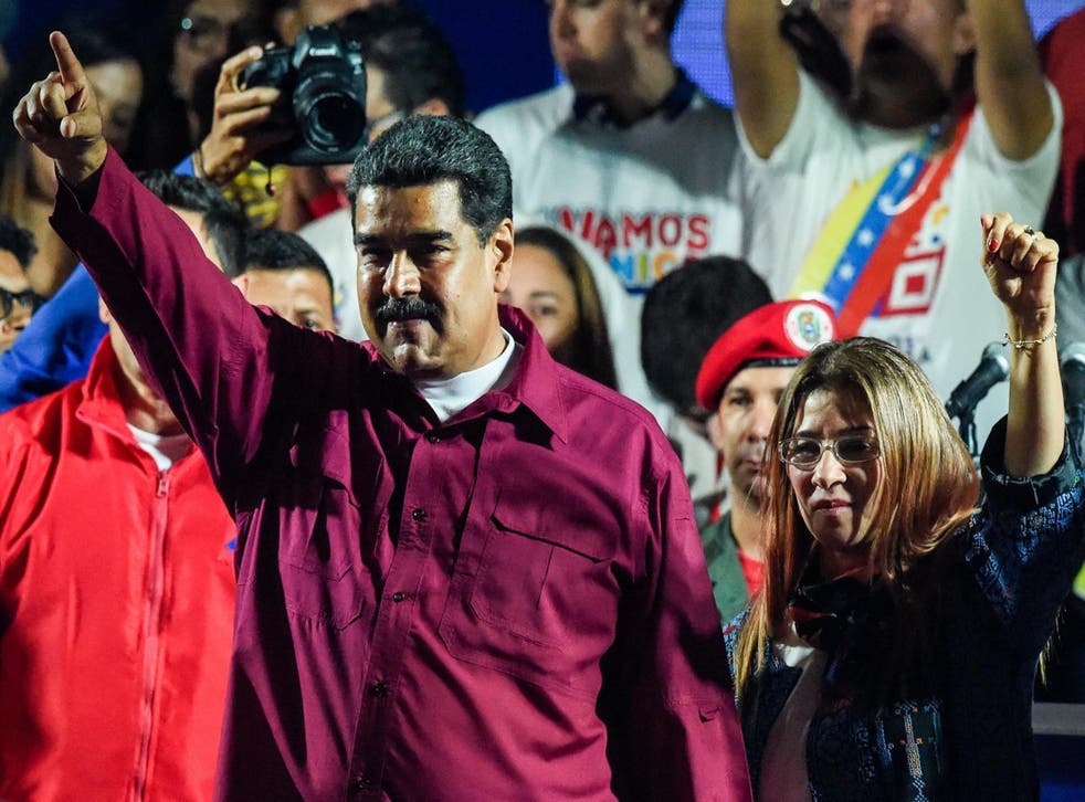 Venezuelan President Nicolas Maduro (L) celebrates with his wife Cilia Flores after the results are declared late on Sunday
