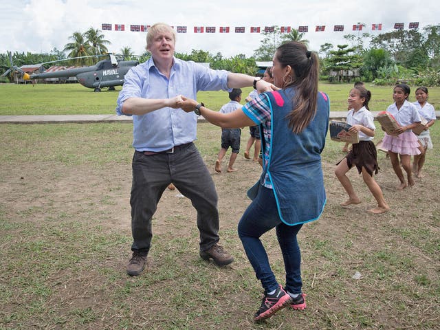 Johnson dances with teacher Adriana Pinedo during a visit to the village primary school in Santa Marta, on the bank of the Amazon near Iquitos in Peru
