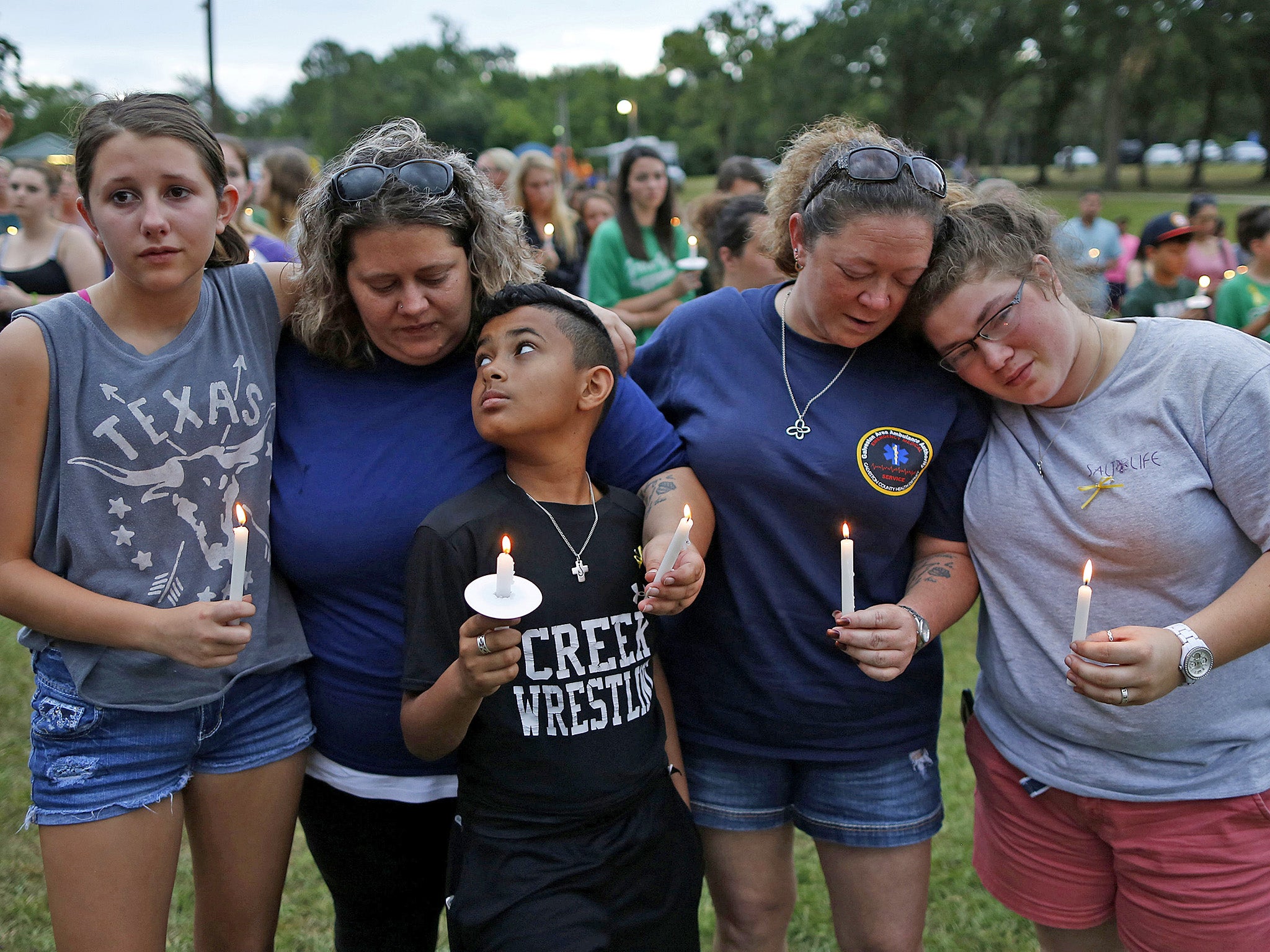 Mourners pray during a vigil in memory of the victims killed in the Santa Fe shooting