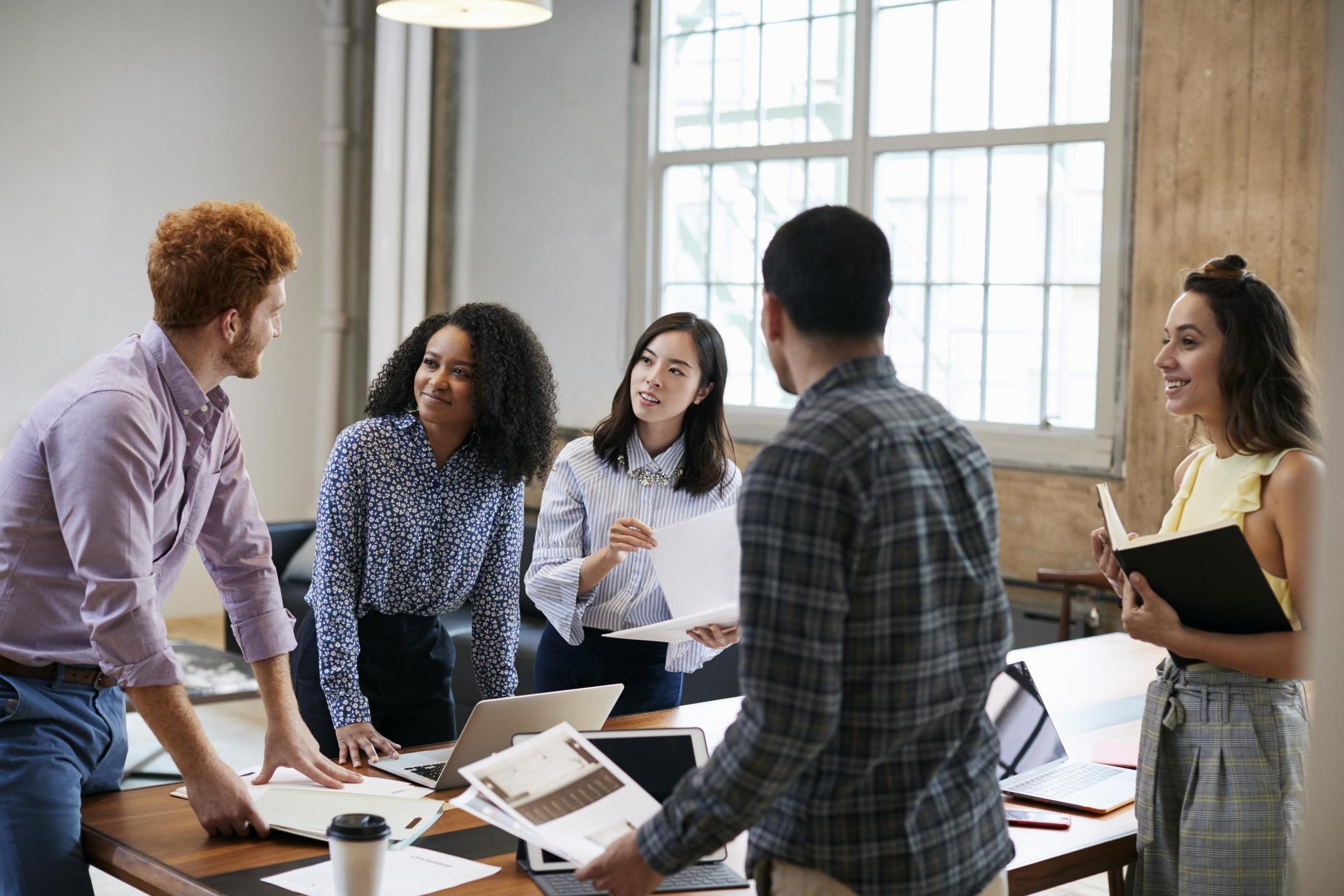 Employee Conducting Survey Among People At Door Stock Photo