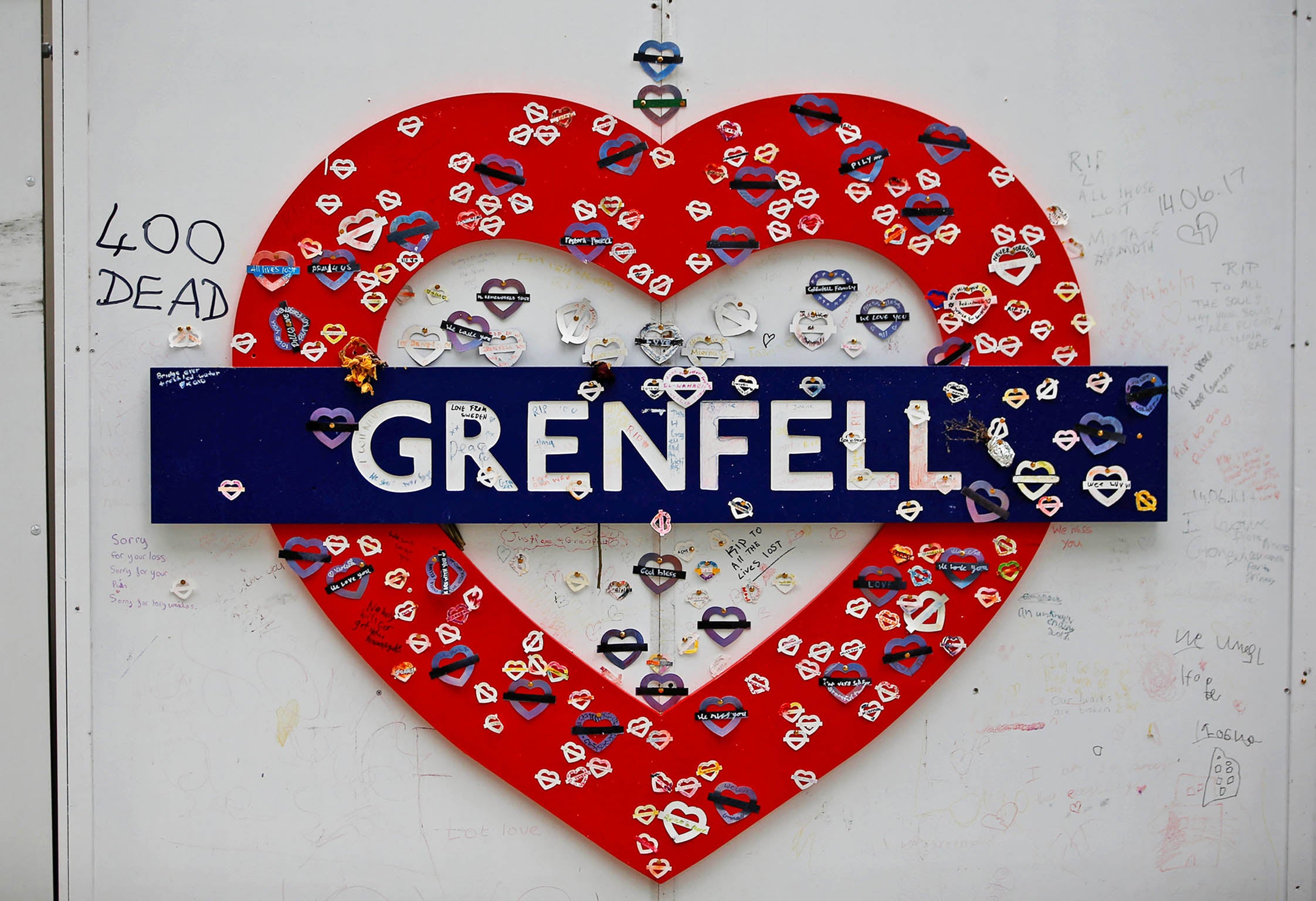 A tribute hangs from a hoarding surrounding Grenfell Tower on the day of a commemoration hearing at the opening of the inquiry into the disaster at the tower, in west London