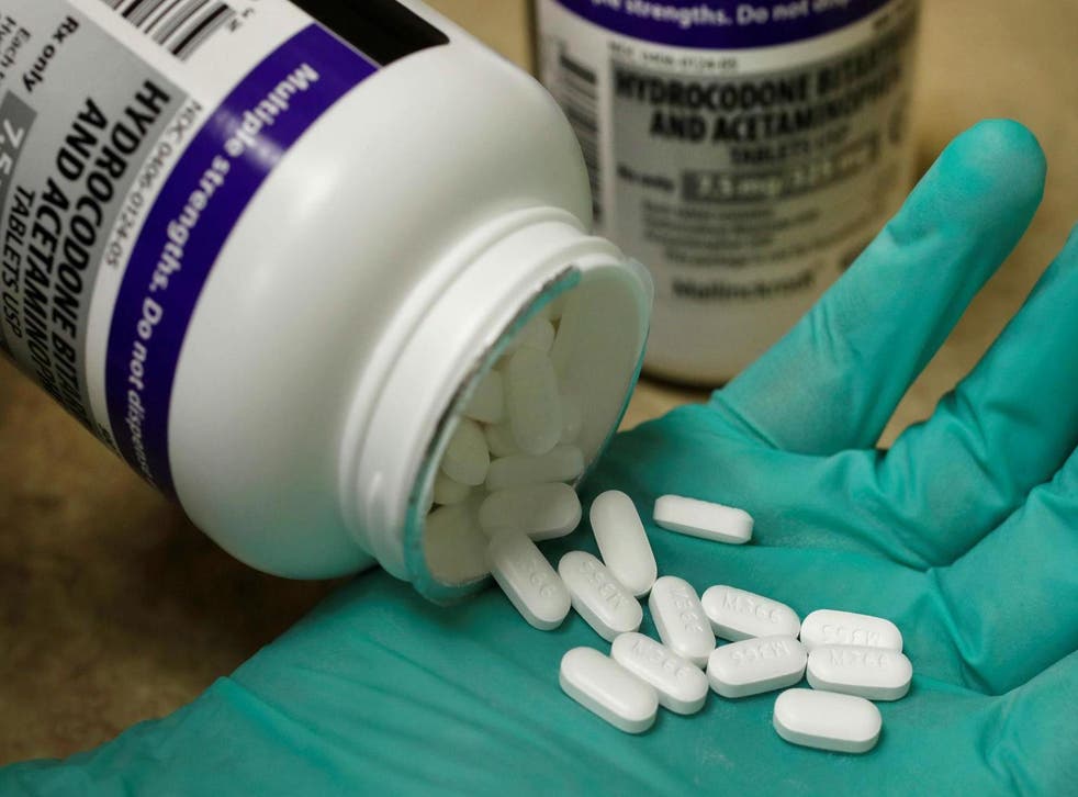 A pharmacist holds the prescription opioid hydrocodone