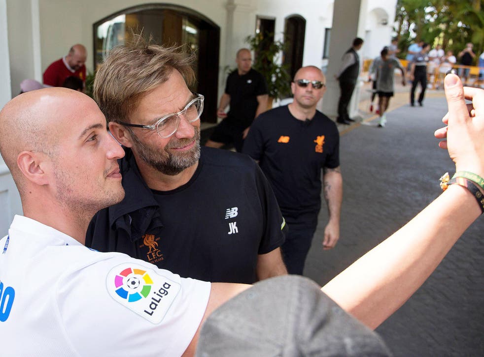 Jurgen Klopp poses with a football fan in Spain