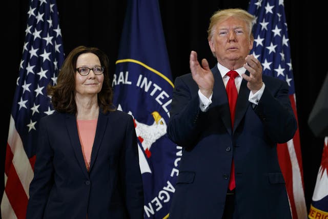 President Donald Trump applauds incoming Central Intelligence Agency director Gina Haspel during a swearing-in ceremony at CIA Headquarters, 21 May 2018, in Langley, Virginia.