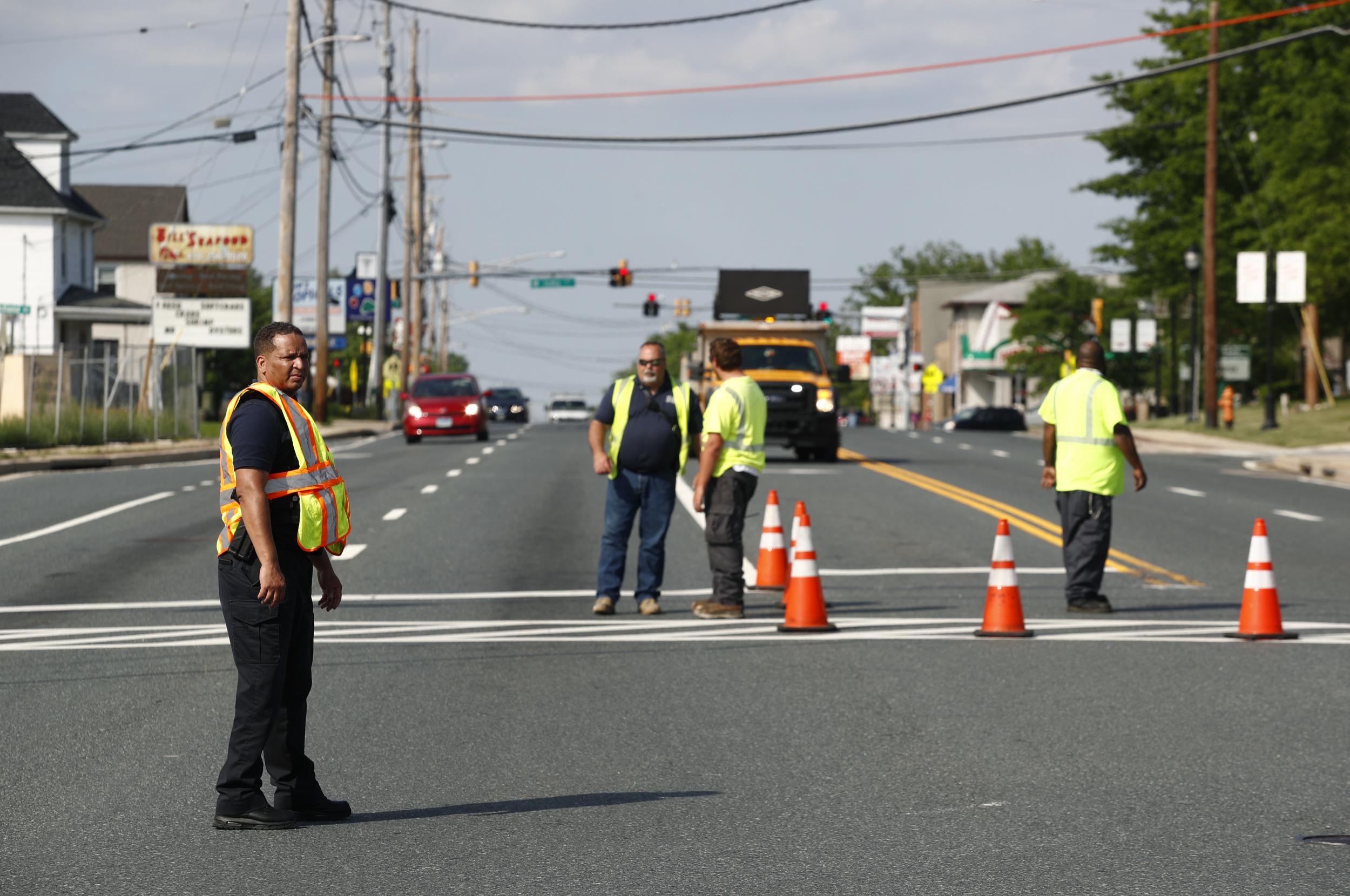 Officials guard a roadblock near a scene where a Baltimore County police officer died while investigating a suspicious vehicle