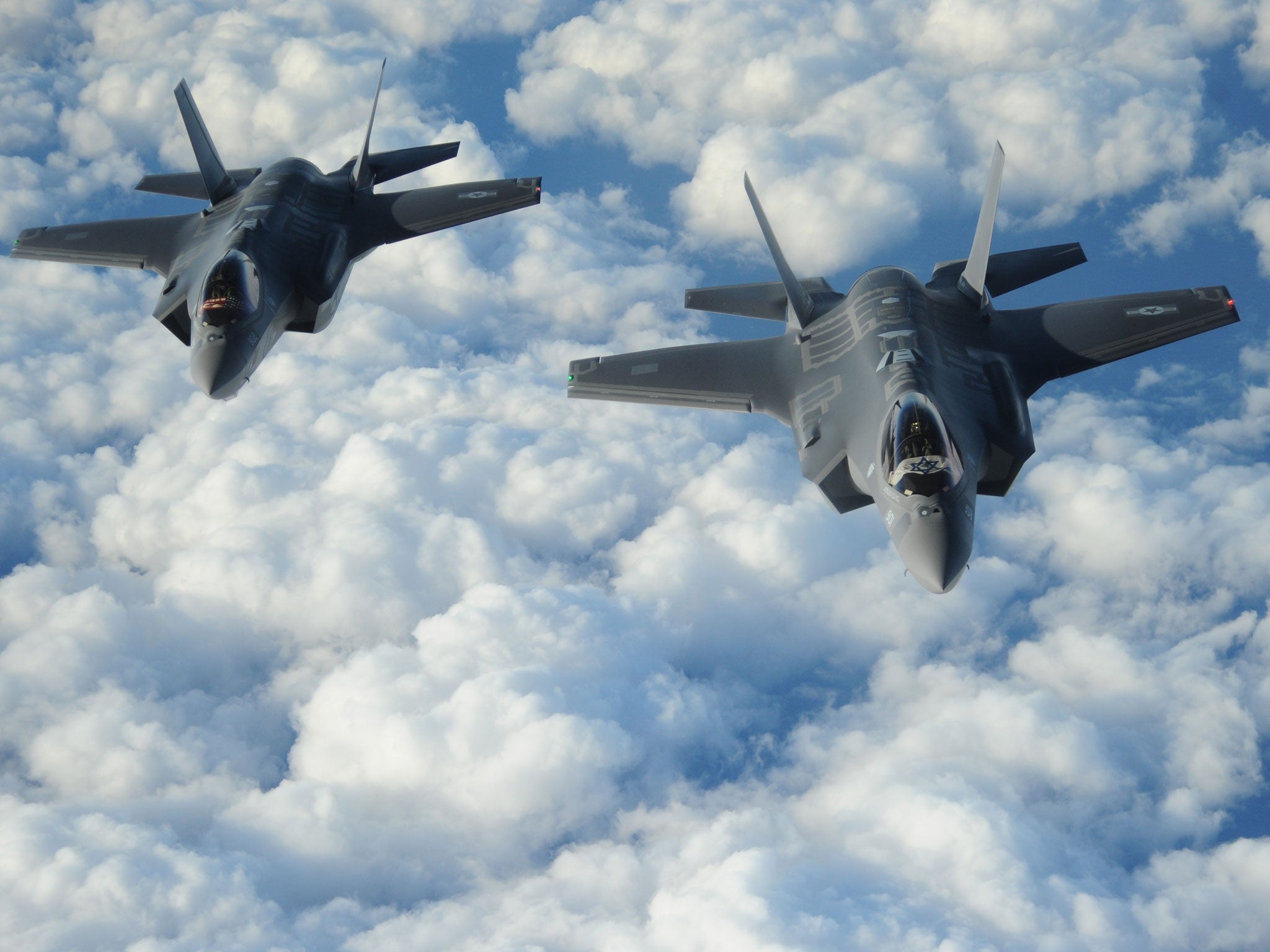 Two Israeli F-35 'Adirs' fly in formation, displaying the US and Israeli flags