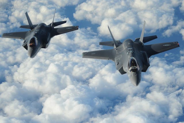 Two Israeli F-35 'Adirs' fly in formation, displaying the US and Israeli flags